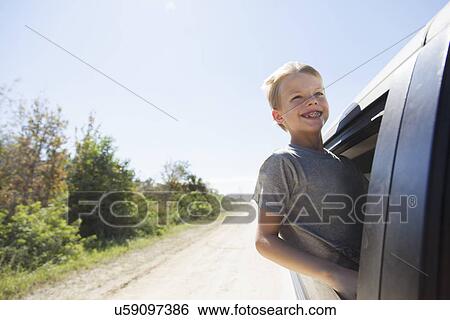 Boy having fun leaning out of truck window View Large Photo Image Stock Photograph - Boy having fun leaning out of truck window. Fotosearch