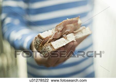 Boy holding bacon sandwich View Large Photo Image Stock Image - Boy holding bacon sandwich. Fotosearch