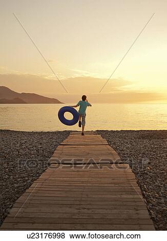 Boy running on boardwalk, Fethiye, Turkey View Large Photo Image Stock Photo - Boy running on boardwalk, Fethiye, Turkey. Fotosearch