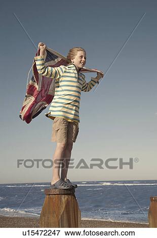 Boy standing on fence post holding union jack flag, Southwold, Suffolk, UK View Large Photo Image Stock Photo - Boy standing on fence post holding union jack flag, Southwold, Suffolk, UK. Fotosearch