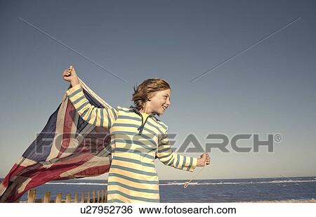 Boy with union jack flag at seaside, Southwold, Suffolk, UK View Large Photo Image Stock Photograph - Boy with union jack flag at seaside, Southwold, Suffolk, UK. Fotosearch