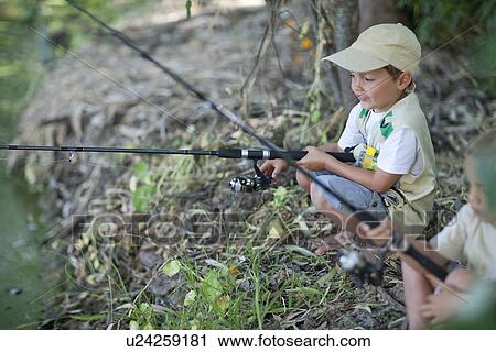 Stock Image - Boys fishing by stream. Fotosearch