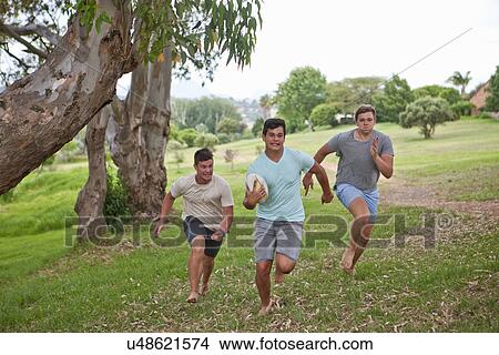 Boys playing touch rugby View Large Photo Image Picture - Boys playing touch rugby. Fotosearch