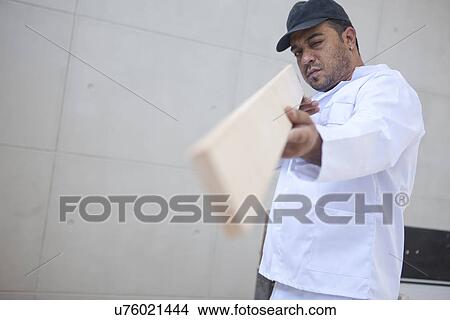 Builder checking wood plank View Large Photo Image Picture - Builder checking wood plank. Fotosearch