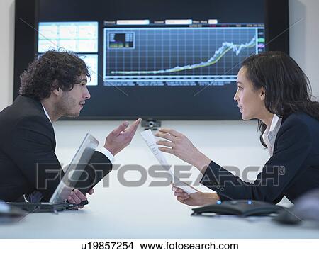 Business colleagues in meeting in front of screen in office View Large Photo Image Picture - Business colleagues in meeting in front of screen in office. Fotosearch