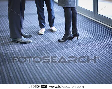 Business colleagues in meeting in office foyer, low section View Large Photo Image Stock Photography - Business colleagues in meeting in office foyer, low section. Fotosearch