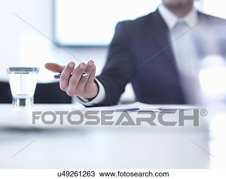 Stock Image - Businessman in meeting, close up. Fotosearch