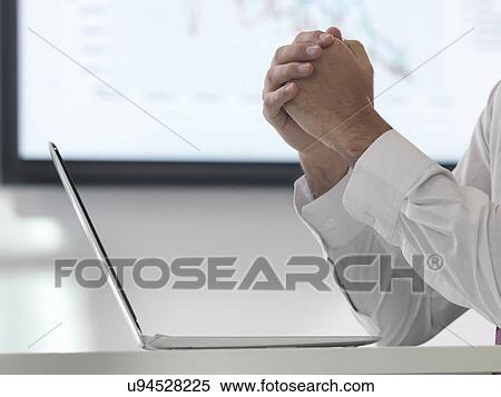 Businessman in meeting using laptop, close up View Large Photo Image Stock Photography - Businessman in meeting using laptop, close up. Fotosearch