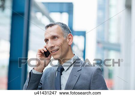 Stock Photo - Businessman talking on smartphone. Fotosearch