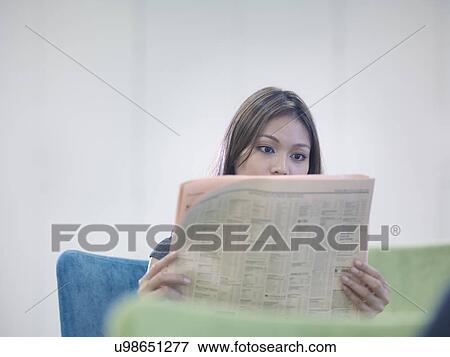 Businesswoman reading British newspaper View Large Photo Image Stock Photo - Businesswoman reading British newspaper. Fotosearch