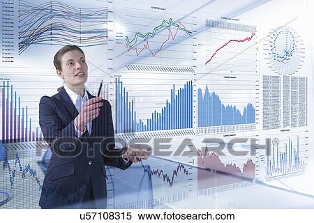 Stock Photography - Businesswoman working with graphs and charts seen through screen. Fotosearch