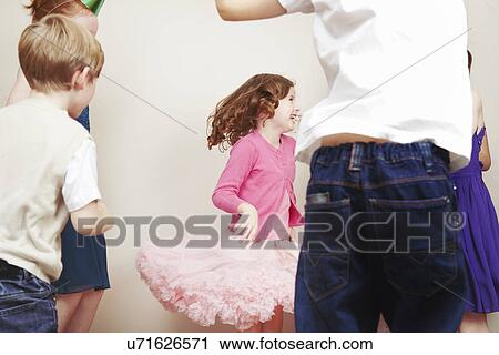 Stock Image - Children dancing at birthday party. Fotosearch