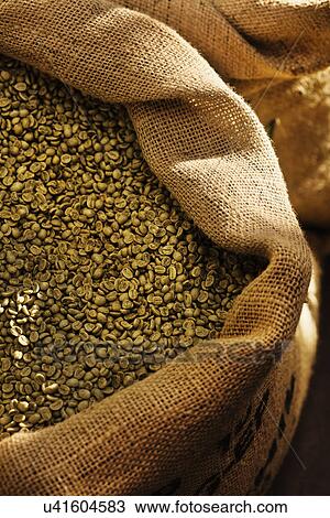 Stock Image - Close up of coffee beans in sack. Fotosearch