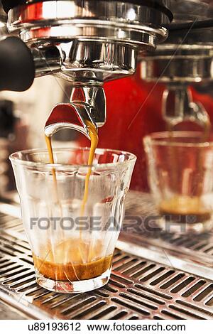 Close up of coffee machine and coffee glass View Large Photo Image Stock Image - Close up of coffee machine and coffee glass. Fotosearch