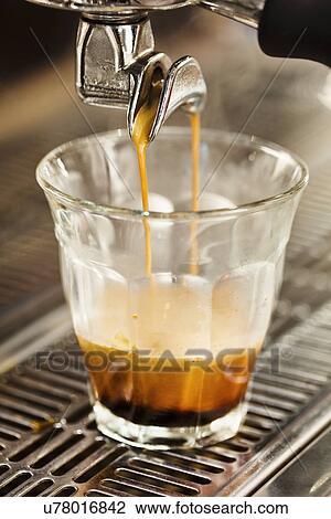 Close up of coffee machine pouring coffee into glass View Large Photo Image Stock Image - Close up of coffee machine pouring coffee into glass. Fotosearch