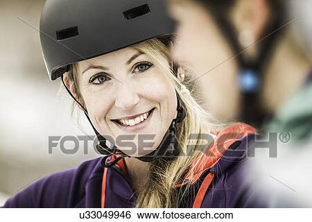Close up of two female mountain bikers chatting View Large Photo Image Stock Photograph - Close up of two female mountain bikers chatting. Fotosearch