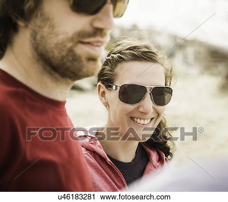 Stock Image - Close up of young couple at beach. Fotosearch