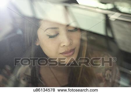 Close up of young woman in car with eyes closed View Large Photo Image Stock Photo - Close up of young woman in car with eyes closed. Fotosearch