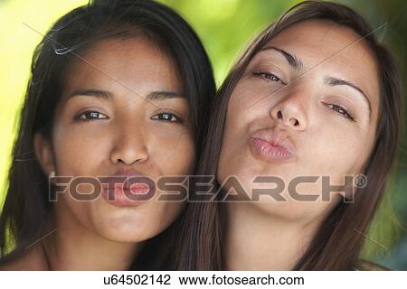 Close up portrait of two woman friends puckering lips View Large Photo Image Stock Image - Close up portrait of two woman friends puckering lips. Fotosearch