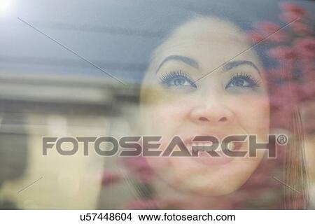 Close up portrait of young woman looking out of car window View Large Photo Image Picture - Close up portrait of young woman looking out of car window. Fotosearch