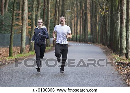 Couple running through forest View Large Photo Image Stock Image - Couple running through forest. Fotosearch