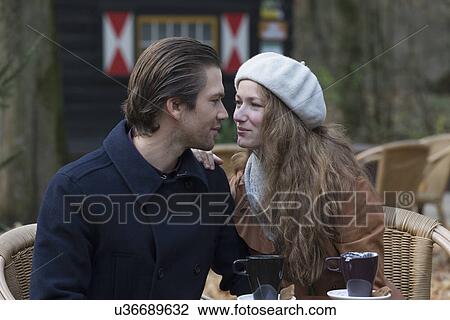 Couple sitting at outdoor cafe View Large Photo Image Stock Image - Couple sitting at outdoor cafe. Fotosearch