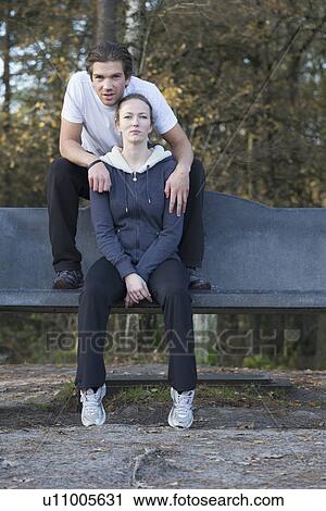 Couple sitting on bench in forest View Large Photo Image Stock Image - Couple sitting on bench in forest. Fotosearch