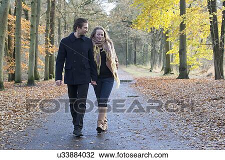 Couple walking through forest View Large Photo Image Stock Image - Couple walking through forest. Fotosearch