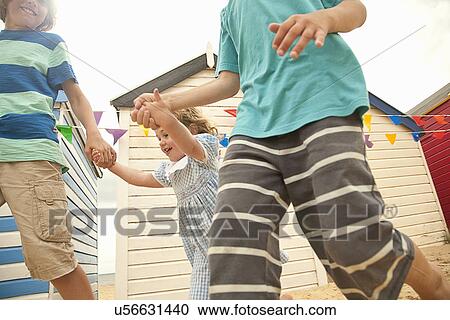 Cropped shot of brothers and toddler sister running, Southwold, Suffolk, UK View Large Photo Image Stock Image - Cropped shot of brothers and toddler sister running, Southwold, Suffolk, UK. Fotosearch