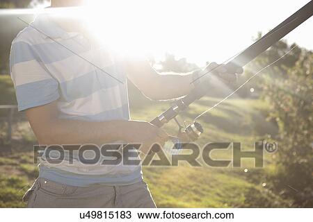 Cropped shot of mature man fishing View Large Photo Image Stock Image - Cropped shot of mature man fishing. Fotosearch