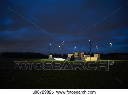 Stock Photography - Distant view of skateboard park at night. Fotosearch