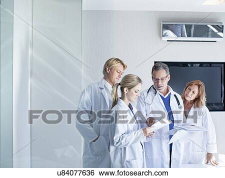 Doctors looking at medical notes View Large Photo Image Stock Photograph - Doctors looking at medical notes. Fotosearch
