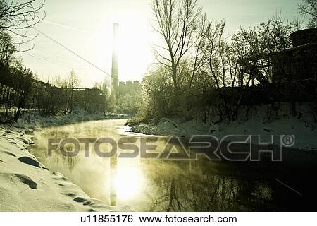 Stock Photograph - Factory chimney and stream, Russia. Fotosearch