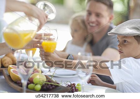 Family dining outdoors View Large Photo Image Stock Photo - Family dining outdoors. Fotosearch