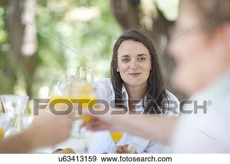 Stock Photo - Family toasting outdoors. Fotosearch
