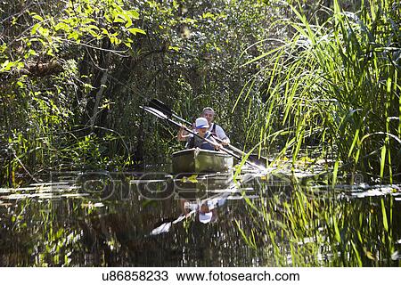 Father and son in a rowing boat, Everglades, Florida, USA View Large Photo Image Stock Image - Father and son in a rowing boat, Everglades, Florida, USA. Fotosearch