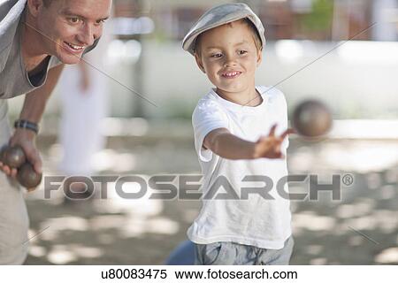 Father and son playing boules View Large Photo Image Stock Photography - Father and son playing boules. Fotosearch