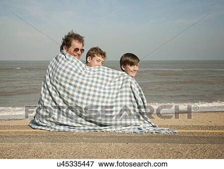 Father and sons on beach View Large Photo Image Stock Photo - Father and sons on beach. Fotosearch