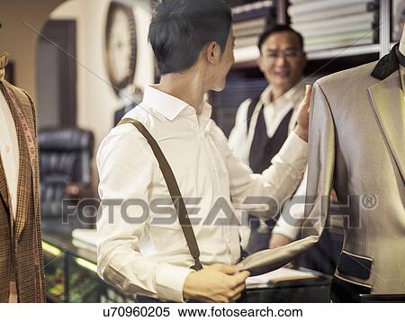 Father teaching son in family tailors shop View Large Photo Image Stock Photography - Father teaching son in family tailors shop. Fotosearch