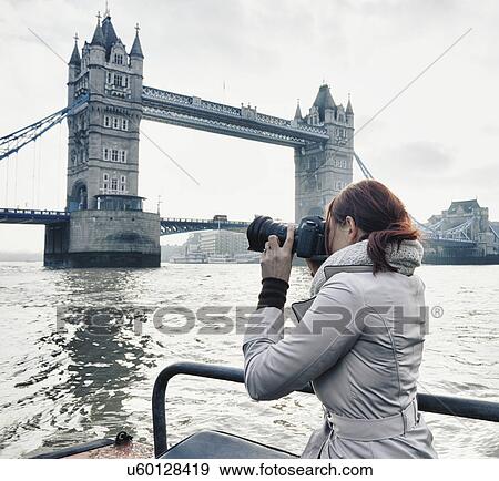 Female photographer taking photograph of Tower Bridge London, UK View Large Photo Image Stock Photo - Female photographer taking photograph of Tower Bridge London, UK. Fotosearch