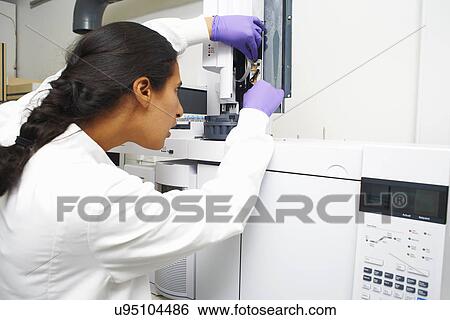 Female scientist using scientific machinery View Large Photo Image Stock Photograph - Female scientist using scientific machinery. Fotosearch