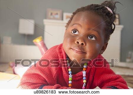 Female toddler lying on sitting room floor View Large Photo Image Stock Image - Female toddler lying on sitting room floor. Fotosearch