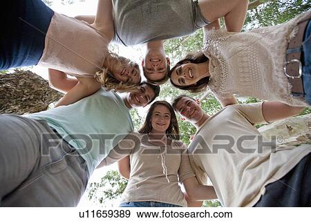 Friends forming circle View Large Photo Image Stock Photo - Friends forming circle. Fotosearch