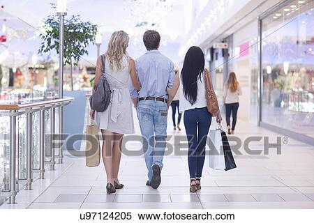 Friends on shopping spree in mall View Large Photo Image Stock Photography - Friends on shopping spree in mall. Fotosearch