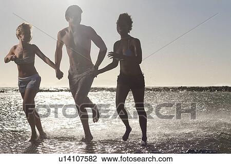 Friends running in sea View Large Photo Image Stock Image - Friends running in sea. Fotosearch