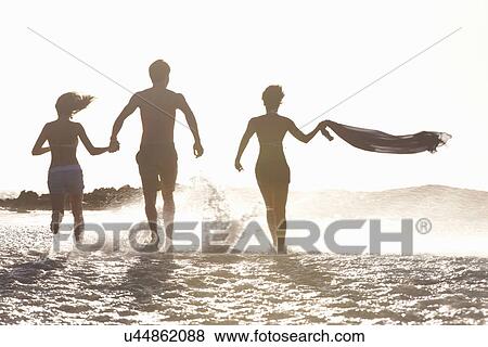 Friends running in sea View Large Photo Image Stock Photo - Friends running in sea. Fotosearch
