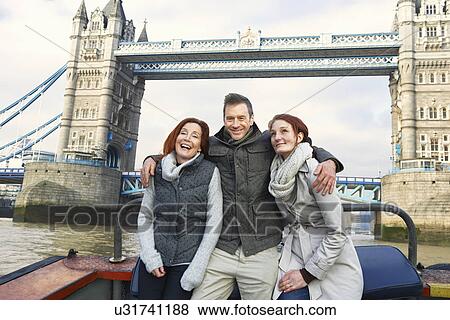 Friends sightseeing on Thames boat, London, UK View Large Photo Image Stock Photo - Friends sightseeing on Thames boat, London, UK. Fotosearch