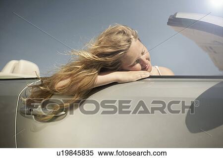 Girl daydreaming in sports convertible View Large Photo Image Stock Photography - Girl daydreaming in sports convertible. Fotosearch