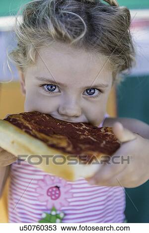 Girl eating slice of pizza View Large Photo Image Stock Image - Girl eating slice of pizza. Fotosearch