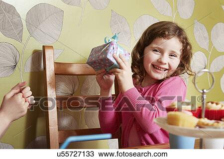 Girl holding birthday present View Large Photo Image Stock Image - Girl holding birthday present. Fotosearch